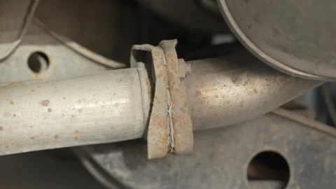 Close-up of a rusty flange connection on car exhaust pipe. Stock Footage 342263191