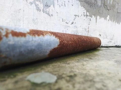 Close-up of a rusty metal pipe with peeling paint. Stock Photos