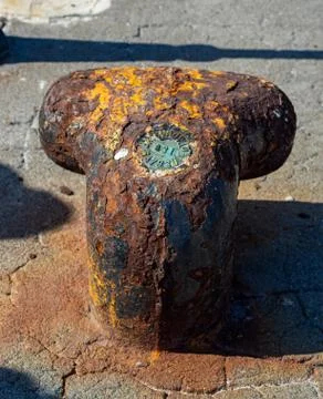 Close-up of a rusty mooring post on the waterfront Stock Photos