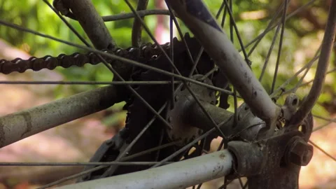 Close-up of an rusty old bicycle chain and rear gear mechanism outdoors Stock Footage 340579806