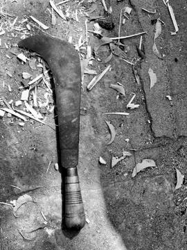 Close up of rusty old machete on ground, black and white, copy space Stock Photos