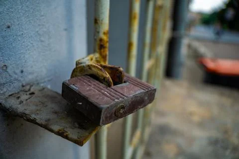 Close-Up of a Rusty Padlock Securing a Metal Gate. limited access internet Stock Photos