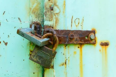 Close-Up of Rusty Padlocks On An Old Metal Door.. Stock Photos