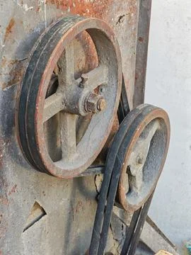 Close-Up of Rusty Pulley Wheels with Rubber Belt on Industrial Machinery Stock Photos