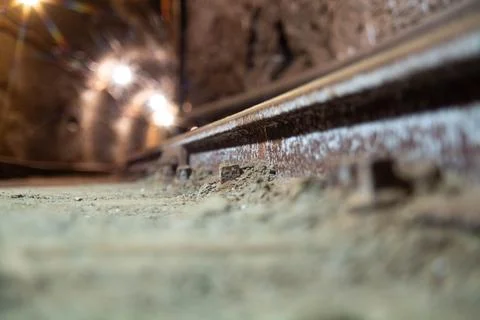 Close-up of a rusty rail in a dark underground mine Stock Photos
