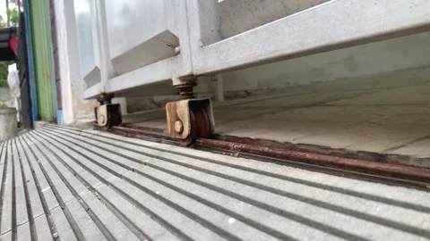 Close Up of Rusty Rolling Shutter Door Wheel Track in Motion 스톡 동영상 339405836