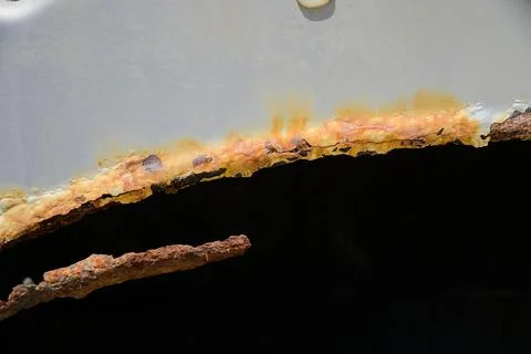 Close-up of rusty wheel arches on a silver car. automobile corrosion and the Stock Photos
