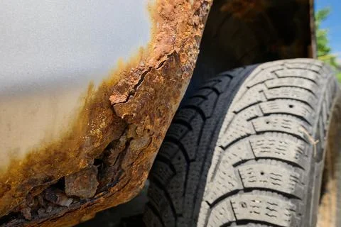 Close-up of rusty wheel arches on a silver car. automobile corrosion and the Stock Photos