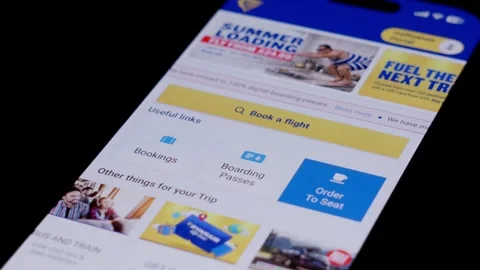 Close-up of the Ryanair app being opened from a smartphone home screen and Stock Footage 334059972
