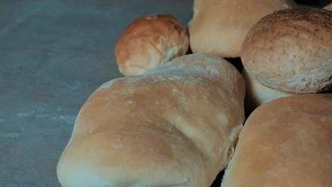 Close-up of rye bread lying on a gray surface and spinning. macro Stock Footage 220522113