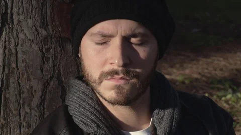 Close up on Sad and depressed man the park opens his eyes Video stock 74729480