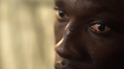 Close up on sad and resigned look of young african man looking away Stock Footage 240328231