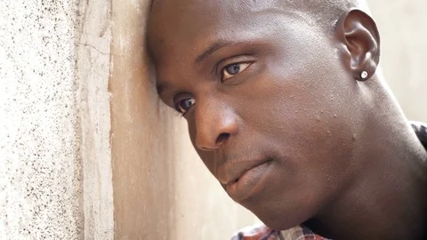 Close up on sad desperate african migrant :despair, fear, sadness Stock Footage