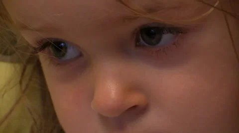 Close-up of the sad eyes of a little girl slide into focus. Slider. Stock Footage