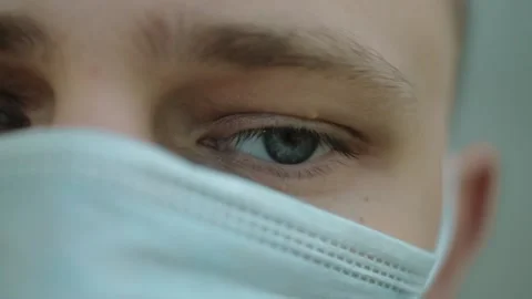 Close-up of a sad guy in a mask during a pandemic Stock Footage 140741303