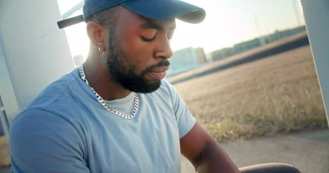 Close up of sad lonely man sitting of ground stressed and tired in morning Video stock 140739826