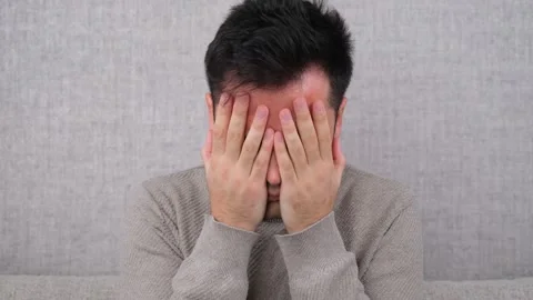 Close Up of Sad Man Covering Face with Hand Stock Footage 260171730