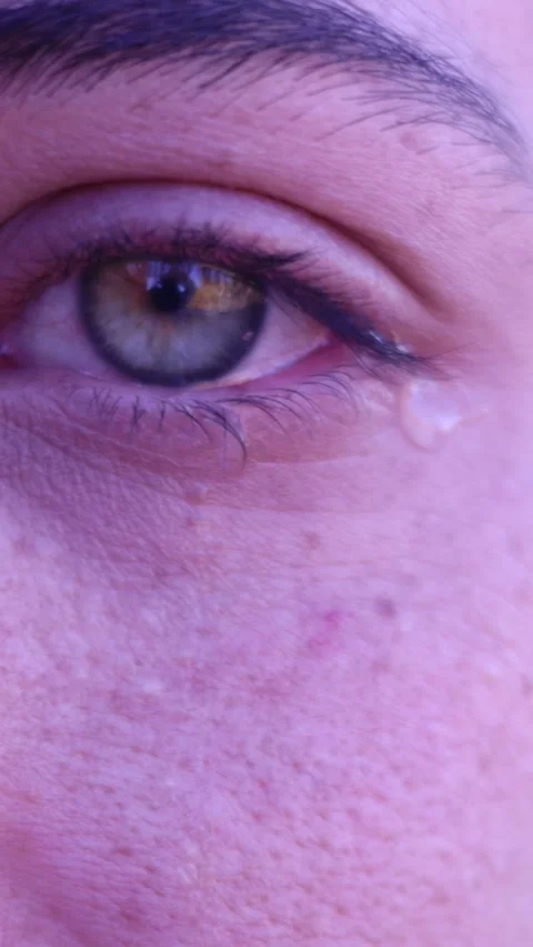 Close-up of sad woman's eye with tear rolling down her cheek Stock Footage 327408039