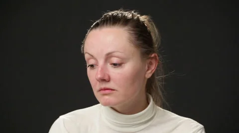 Close up sad woman's face, she is touching the face and the head, looking down Stock Footage 64057332
