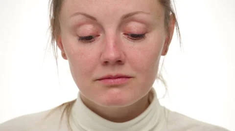 Close up sad woman's face, she is looking down, then to the side and touching Stock Footage 64057665