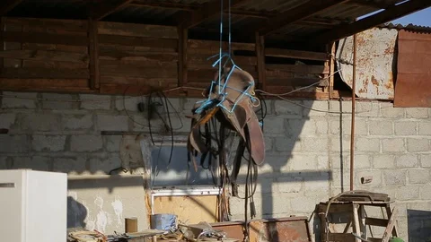 Close up saddle hanging on rope and spinning under street canopy Video stock 124315948
