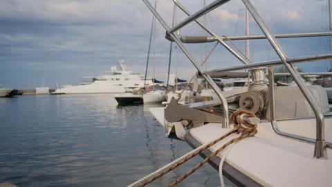 Close up of a sailboat bow, anchor, ropes, and metal railings at Port Vauban Видео 339748923
