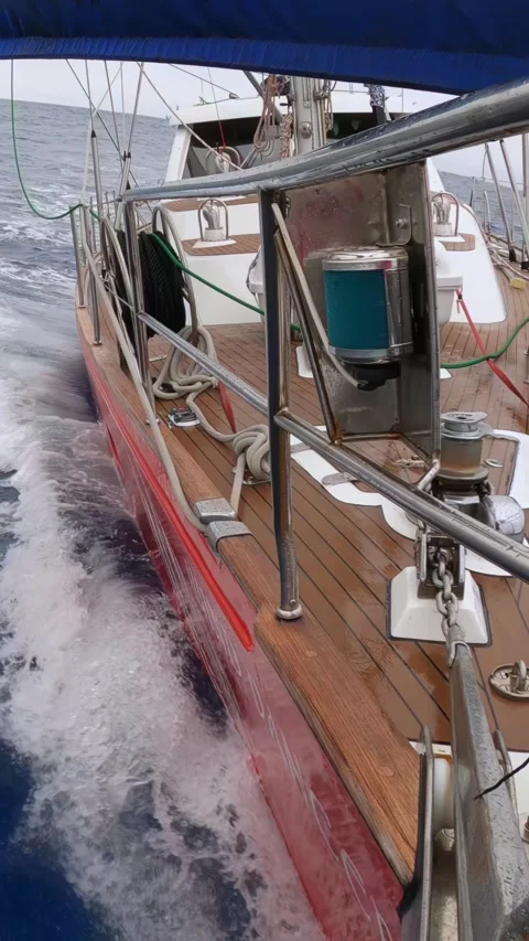 Close-up of a Sailboat Navigating through Waves on the Open Sea Stock Footage 276238279