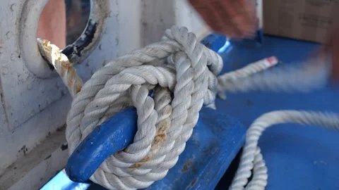Close-up of a sailor mooring a ship with a rope Stock Footage 281144925