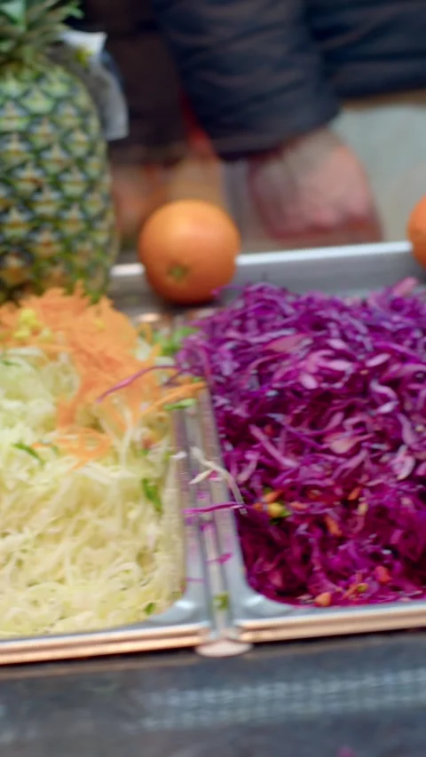 Close-up of salad bar tray with shredded lettuce, grated carrot, and peas beside 動画素材 336534327