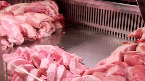 Close-up of salesman puts the raw red meat ribs on the window display Stock Footage 171953979