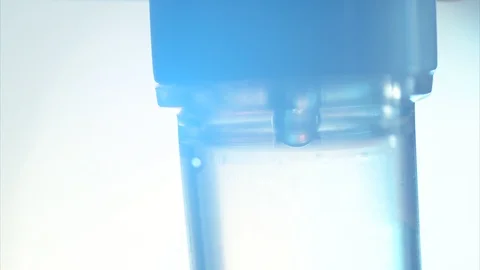 Close up saline dropping solution tube on white bright background in hospital Видео 98408801