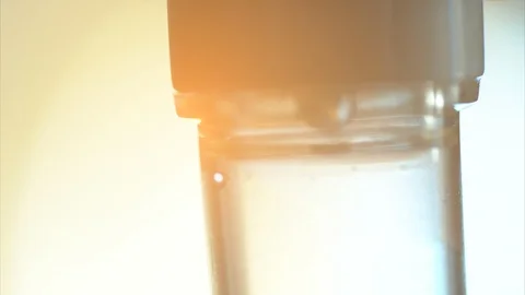 Close up saline dropping solution tube on white bright background in hospital Stock Footage 98409277