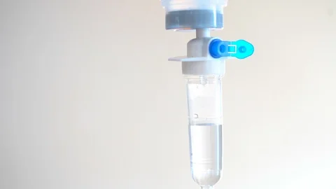 Close up saline dropping solution tube on white bright background in hospital 库存影片 98410718