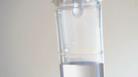 Close up saline dropping solution on white bright background Stock Footage 99690142
