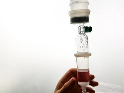 Close up saline solution drip for patient and infusion pump in hospital. Stock Photos