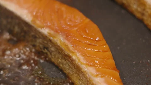 Close-up of Salmon with Crispy Skin Cooking with Soy Sauce Bubbling. Stock Footage 346223598