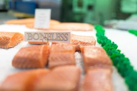 Close up of salmon fillets spread over ice on a fish mongers market stall Stock Photos