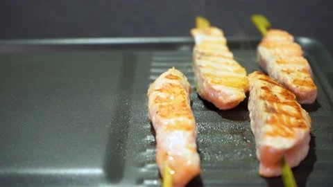 Close up salmon fish skewer in soy bbq marinade sauce frying on pan healthy food Stock Footage 157112736