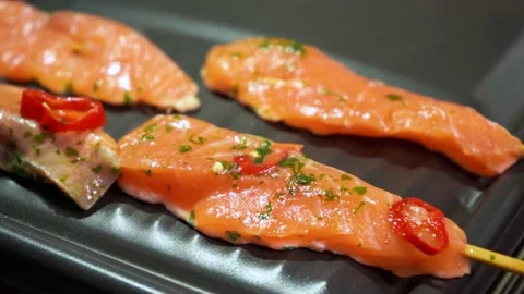 Close up of salmon fish skewers with chilli sliced pieces in soy lemon marinade Stock Footage 159911057