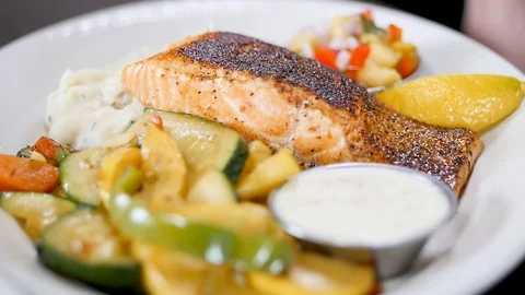 Close up of salmon potato vegetable dish Video stock 94240448