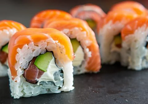 Close up of salmon roll sushi on table Stock Photos