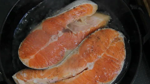 Close-Up Of Salmon Steaks Fried In A Pan Stock Footage 130531722