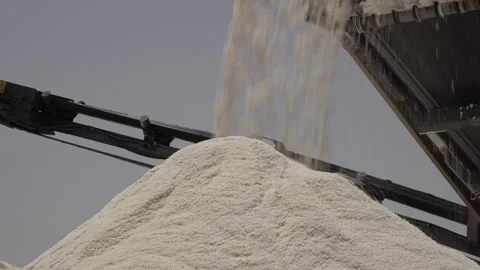 Close-up of salt dropping on huge pile in production facility Sahara Tunisia Stock Footage 319850511
