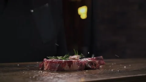 Close Up of Salt Falling On Fresh Beef With Herbs And Garlic. Chef Sprinkle Meat Stock Footage 154558204