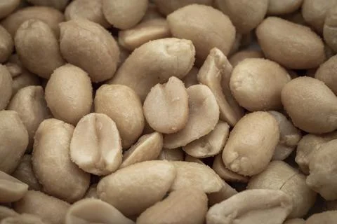 Close up of salted peanuts as a background. Toned Stock Photos