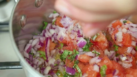 Close-up Salting salsa sauce while boiling in a pan on a gas stove in 4K. Stock Footage 142682754