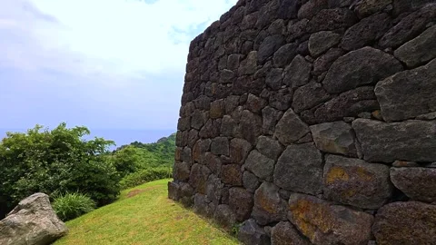 Close-up of Sanbang Yeondae basalt stone beacon wall with coastal headland in Stock Footage 337865392