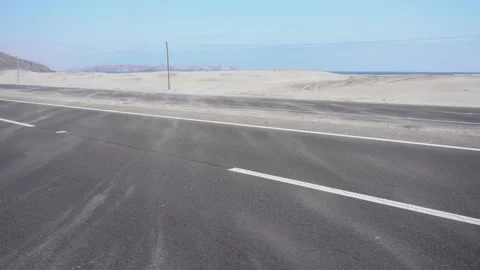 Close-up of the sand being displaced all over the road by the strong gusts of wi Stock Footage 196728767