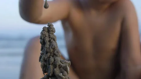 Close up of sand castle on the beach on blue sky background.Slow motion Video stock 50148385