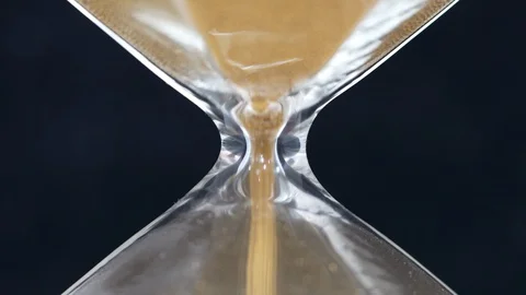 Close-Up on Sand Flowing Through an Hour Glass Stock Footage 127981560